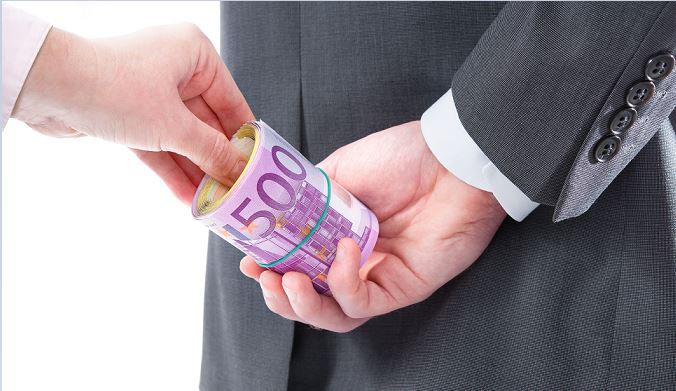 man receiving rubber-banded Euros behind his back