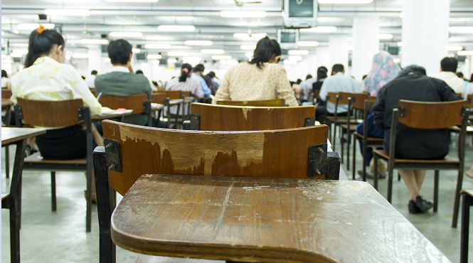 the backs of students' heads as they take a test